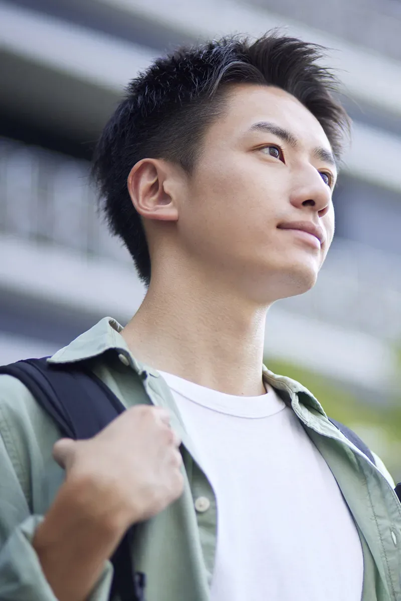 Photo d'un jeune homme japonais regardant au loin.